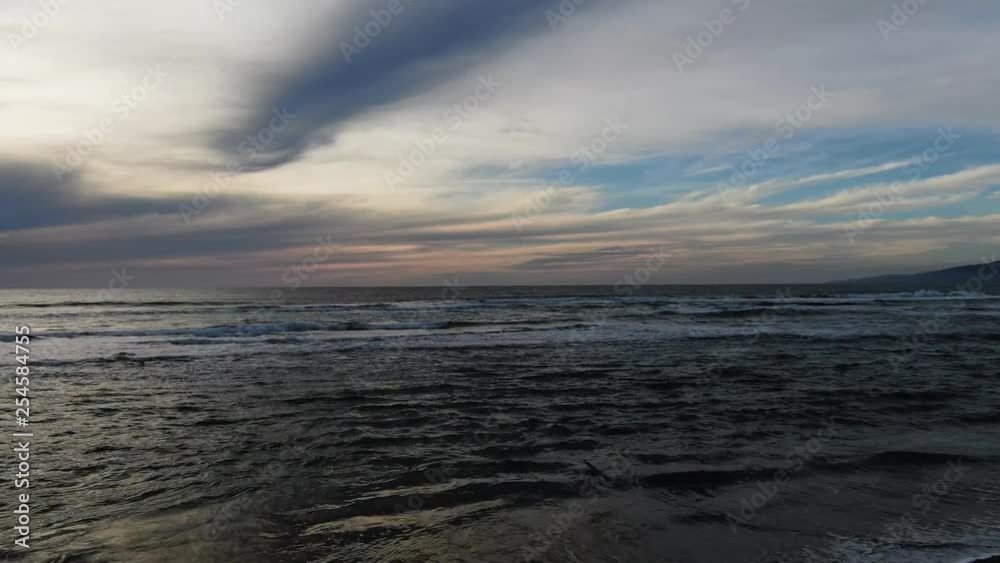 Sunset leaking through cloud cover at beach. Vibrant and beautiful Sunset leaking through cloud cover at beach. Vibrant and beautiful