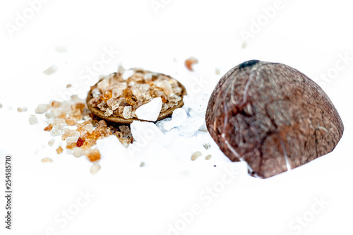 Ingredients to make various ayruvedic medicines isolated on white which are gon katira or edible gum along with coconut.