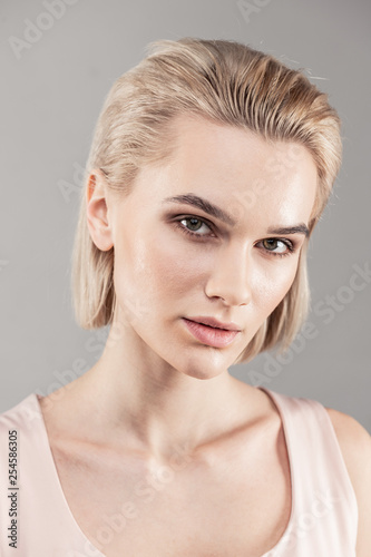 Beautiful short-haired woman with vicious sight and grey eyes