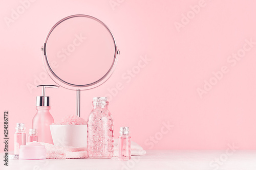 Canvas-taulu Girlish cute bathroom interior in pastel pink color - cosmetic products for skin and body care and round mirror on soft white wood board, copy space