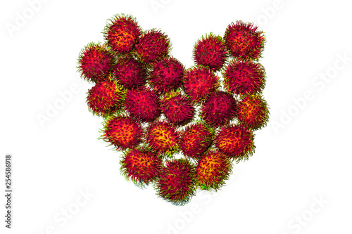 Acid colors heart made of rambutan fruits isolated