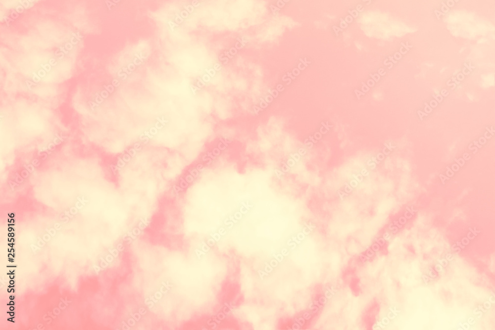 Coral color of the year 2019. Beautiful sky with fluа fy clouds toned coral and pink gradient.