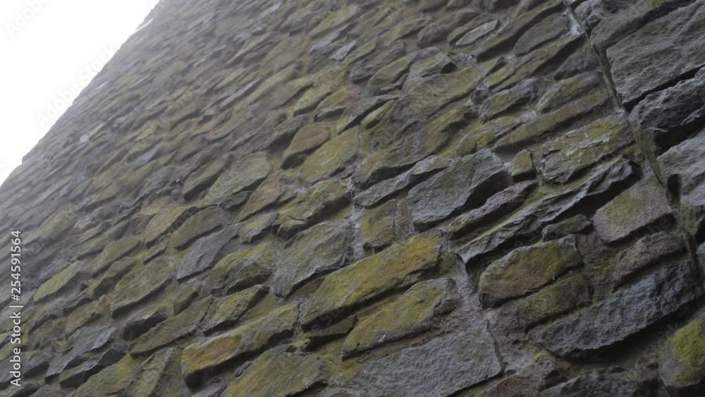 Slow tilt up on creepy stone wall Slow tilt up on creepy stone wall
