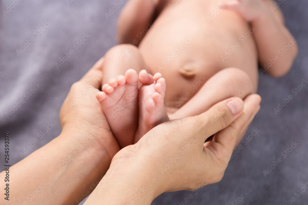 Parent holding feet of newborn baby in the hands Parent holding feet of newborn baby in the hands