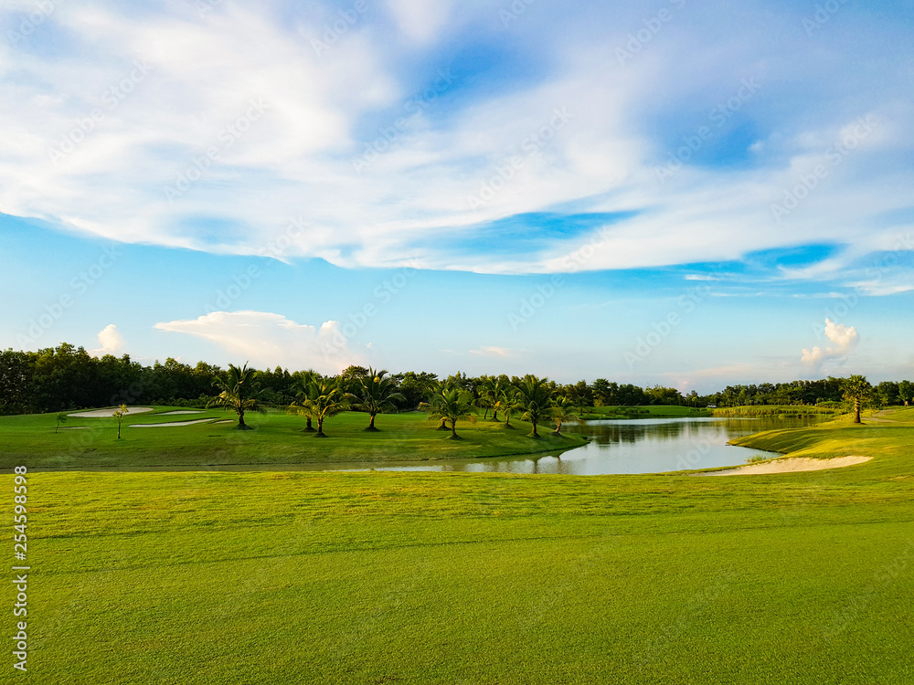 Beautiful fairway  sand bunkers and lake  in the golf course  northern of Thailand with sky background