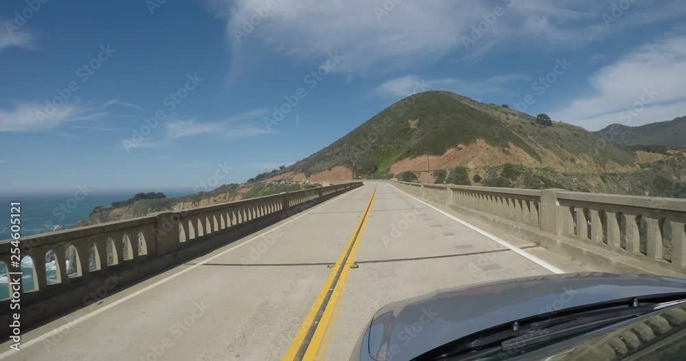 Driving across the Bixby bridge on a sunny day