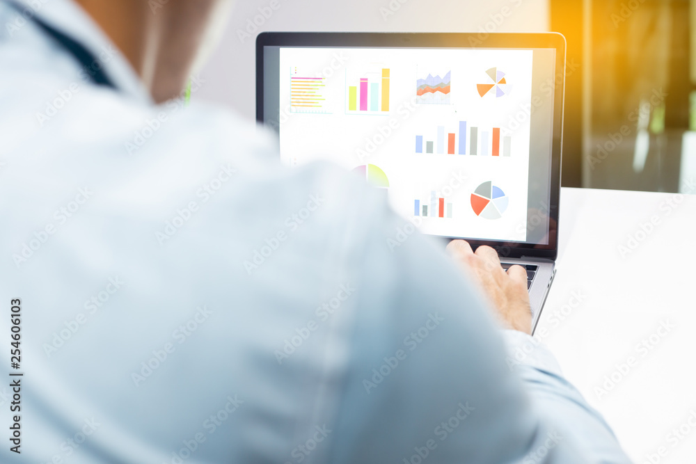 Businessman workspace laptop with coffee cup ,computer screen graphics and chart at office room Businessman workspace laptop with coffee cup ,computer screen graphics and chart at office room