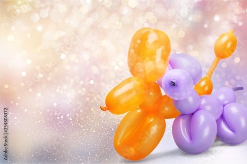 Two balloons in shape of animals on background