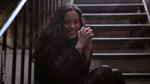 Funny shot of an attractive woman clasping her hands tightly wishing for something
