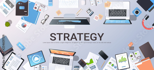 business strategy marketing plan concept top angle view desktop laptop smartphone tablet screen paper documents financial analysis report office stuff horizontal