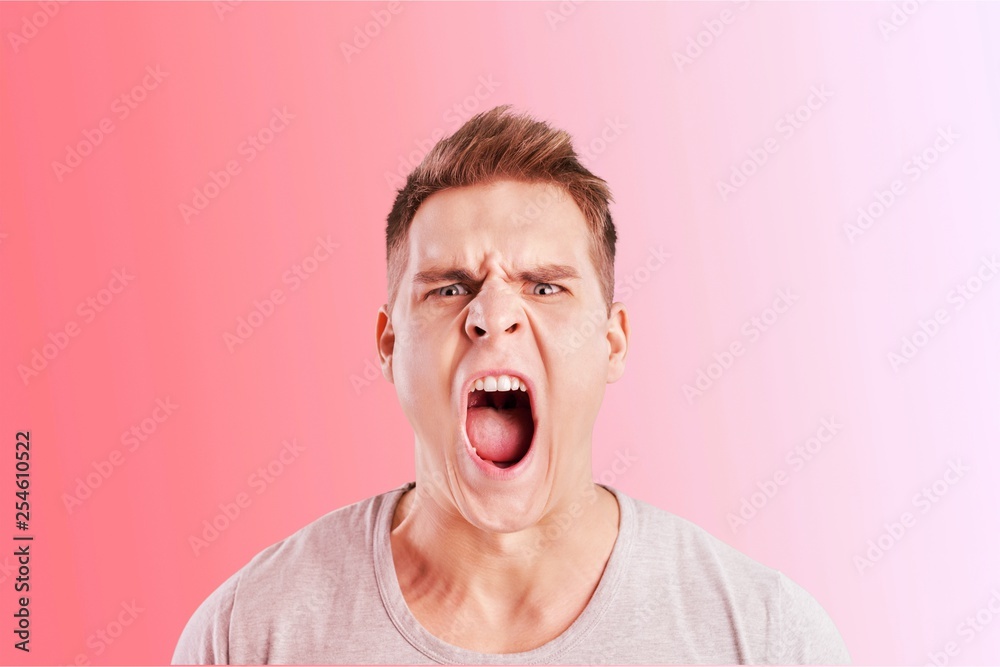 Angry man screaming isolated on background Angry man screaming isolated on background