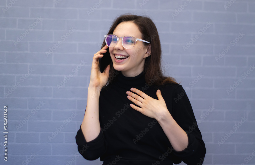 Happy young smiling woman talking on the phone Happy young smiling woman talking on the phone
