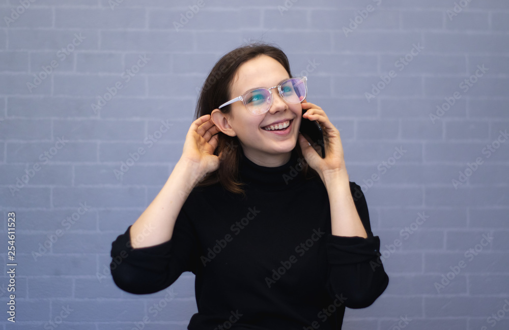 Happy young smiling woman talking on the phone Happy young smiling woman talking on the phone