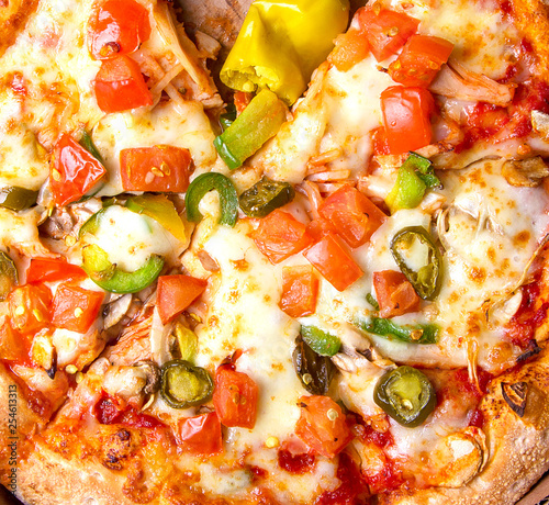 Tasty Italian pizza Mexicano in a box on brown concrete background. Top view of hot pizza with jalapeno pepper , a very hot green chili pepper, used especially in Mexican-style cooking. Flat lay