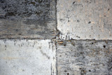 A fragment of a concrete wall with traces of plywood formwork and wood texture