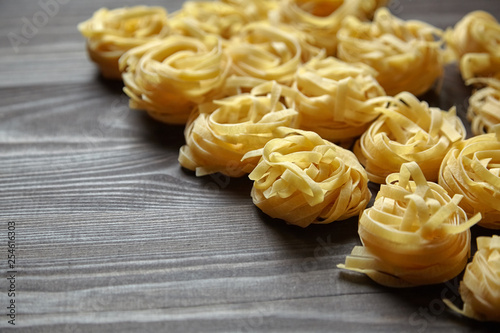Tagliatelle italian pasta on brown wooden table