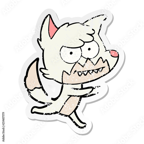 distressed sticker of a cartoon grinning fox