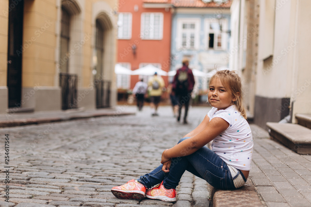 Little adorable cute girl in the street walking. Urban, vacation, travel, childhood concept