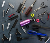 Top view of professional hair dresser tools on black  background