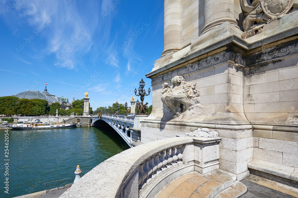 Fototapeta premium Alexandre III bridge with empty balcony in a sunny summer day, blue sky in Paris, France.