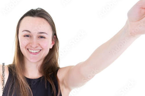millennial teenage girl in black taking a selfie on cellphone in white background