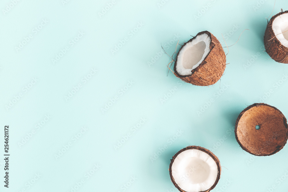 Summer composition. Coconut on pastel blue background. Summer concept. Flat lay, top view, copy space Summer composition. Coconut on pastel blue background. Summer concept. Flat lay, top view, copy space