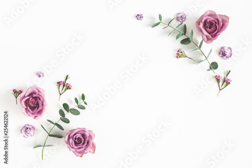 Fototapeta Naklejka Na Ścianę i Meble -  Flowers composition. Frame made of eucalyptus branches and rose flowers on white background. Flat lay, top view, copy space