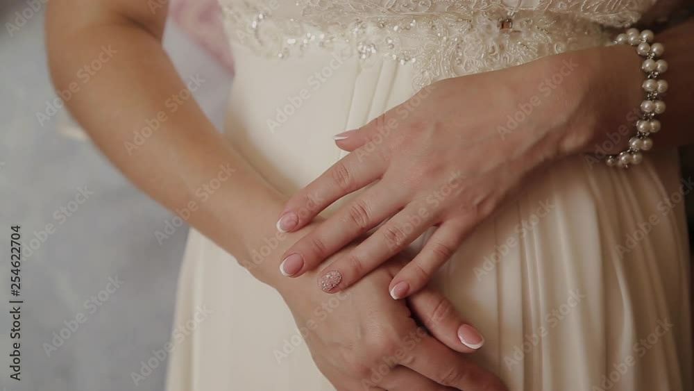 extreme close up of the hands of the bride. Bride in wedding dress close-up of the hands. Close-up hands of the bride on white dress extreme close up of the hands of the bride. Bride in wedding dress close-up of the hands. Close-up hands of the bride on white dress