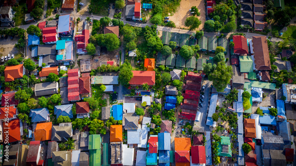 Aerial view of the village in Thailand, Samui island. colored roofs, green trees, sunny weather. 