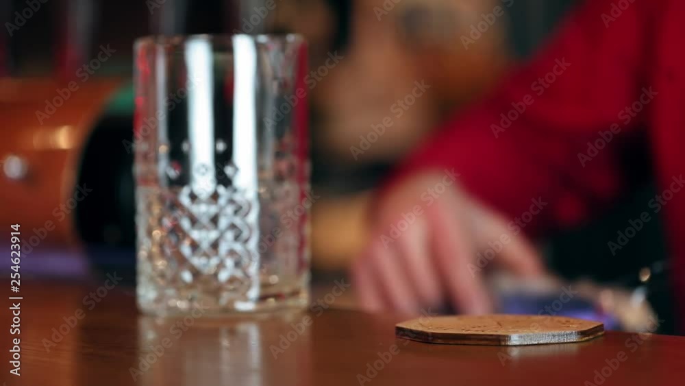 Expert barman is making cocktail at night club. Expert barman is making cocktail at night club.