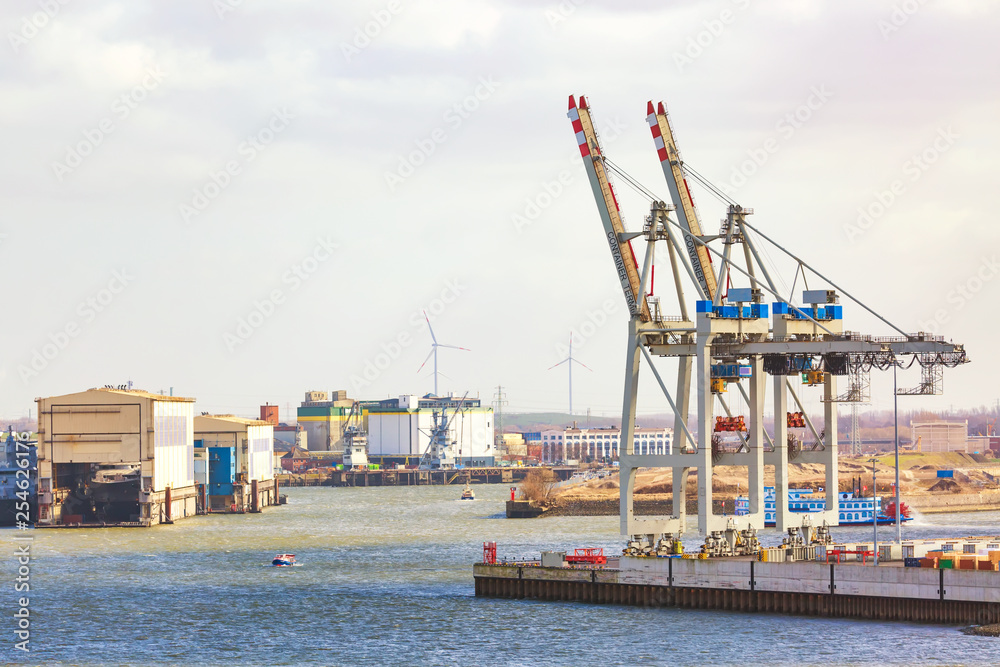 Naklejka premium Cargo port of Hamburg on the river Elbe, the largest port in Germany. Cranes and containers.