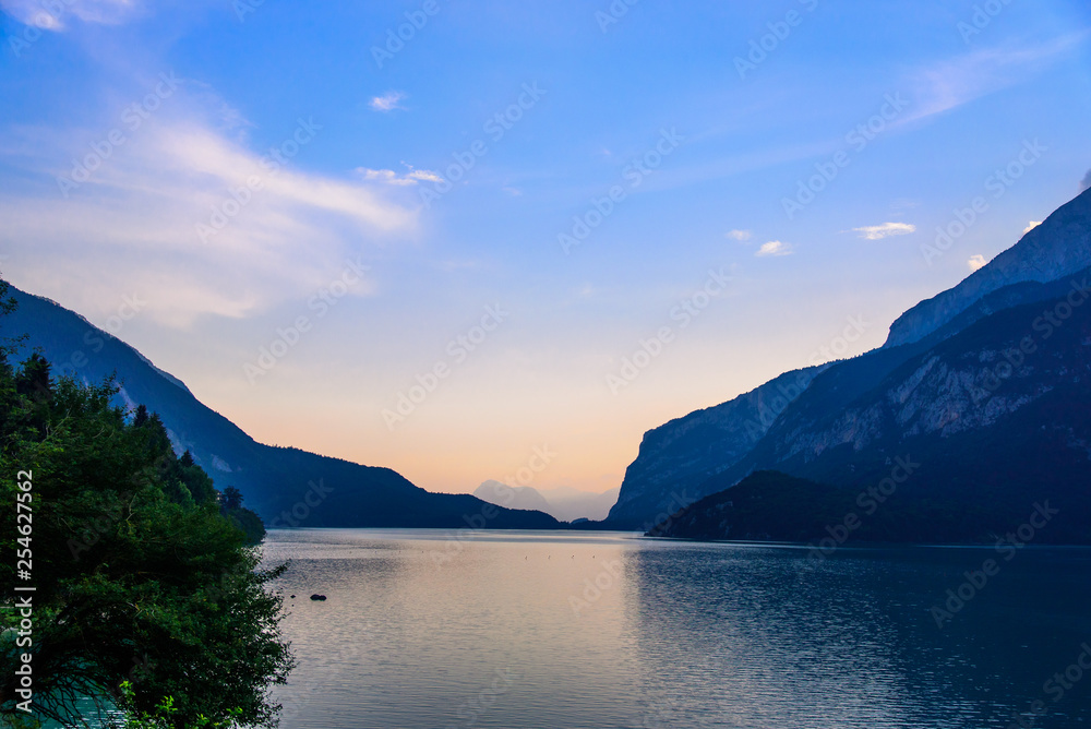 Beautiful colorful sunset on mountain lake Molveno in Italian Alps