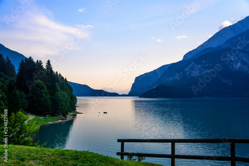 Beautiful colorful sunset on mountain lake Molveno in Italian Alps photo