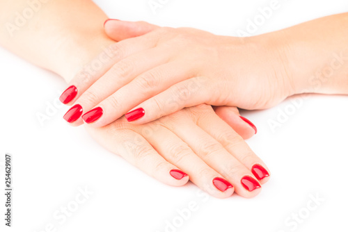 Hands of a young woman with red manicure on nails
