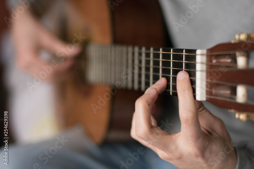 classic acustig guitar player performing, focus on hands