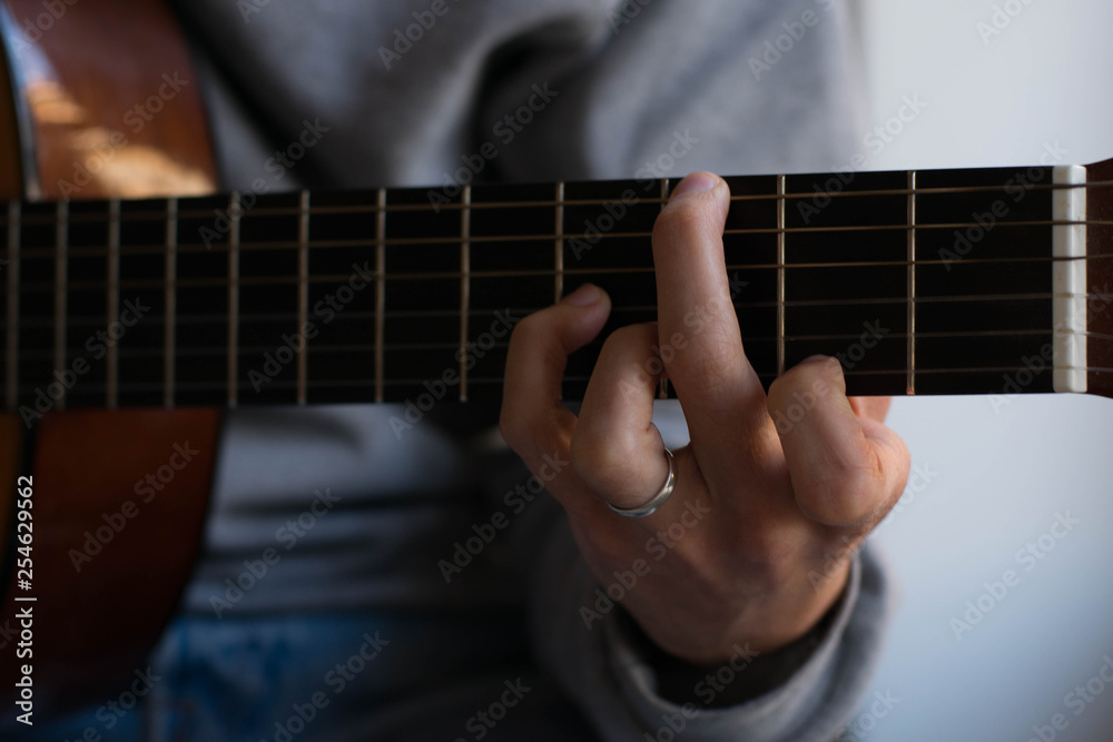 Fototapeta premium classic acustig guitar player performing, focus on hands