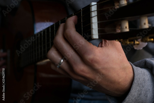 classic acustig guitar player performing, focus on hands