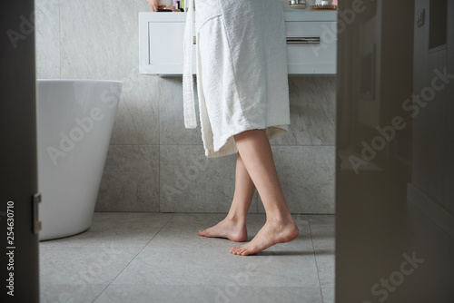 Photography Young barefoot lady in bathroom near washstand