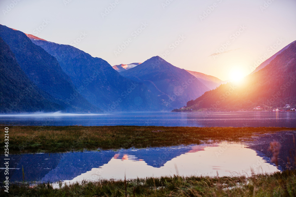 Amazing nature view with fjord and mountains. Beautiful reflection. Location: Scandinavian Mountains, Norway.