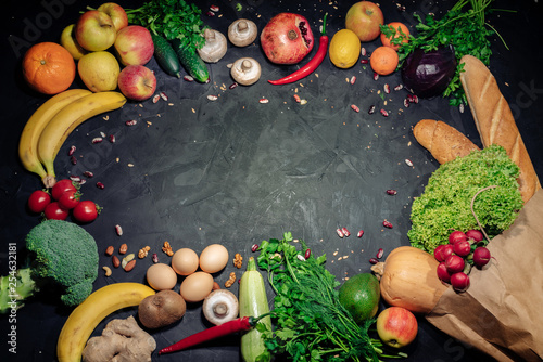 Healthy food background. Fresh vegetables and fruits on dark background. Top view with copy space