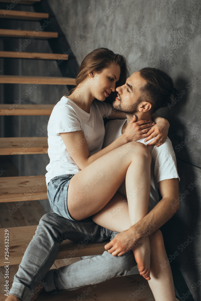 Young romantic couple is kissing and enjoying the company of each other at home Young romantic couple is kissing and enjoying the company of each other at home