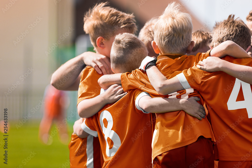 Boys Soccer Football Team Huddle. Children Play Sports Game. Kids Sporty Team United Ready to Play Game. Youth Sports For Children. Boys in Sports Jersey Orange Shirts. Young Boys in Soccer Sportswear
