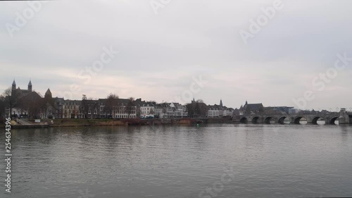 Sint Servaasbrug - St. Servatius Bridge is an arched stone footbridge across the Meuse River in Maastricht, Netherlands, 4k footage cloudy day, wider shot photo