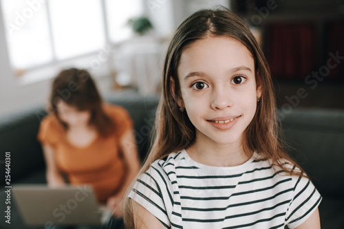 Happy smiling teenager girl staying at living room