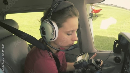 Young woman pilot doing pre-flight checks getting ready to turn the airplane engine on