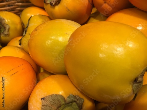 Heap of fresh persimmons photo