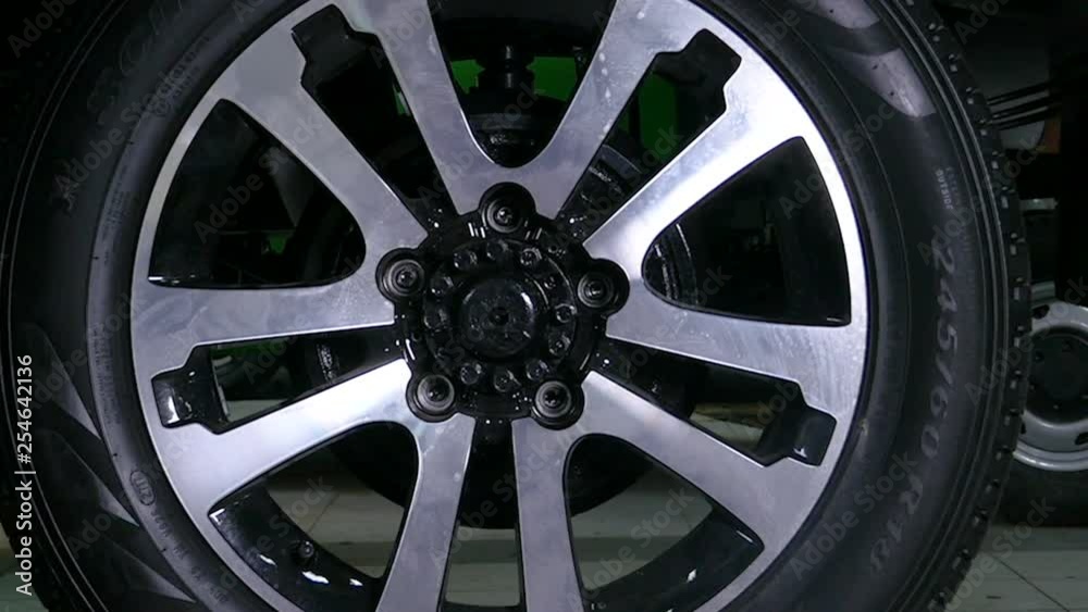 Man in car services removes the wheel from a car Man in car services removes the wheel from a car
