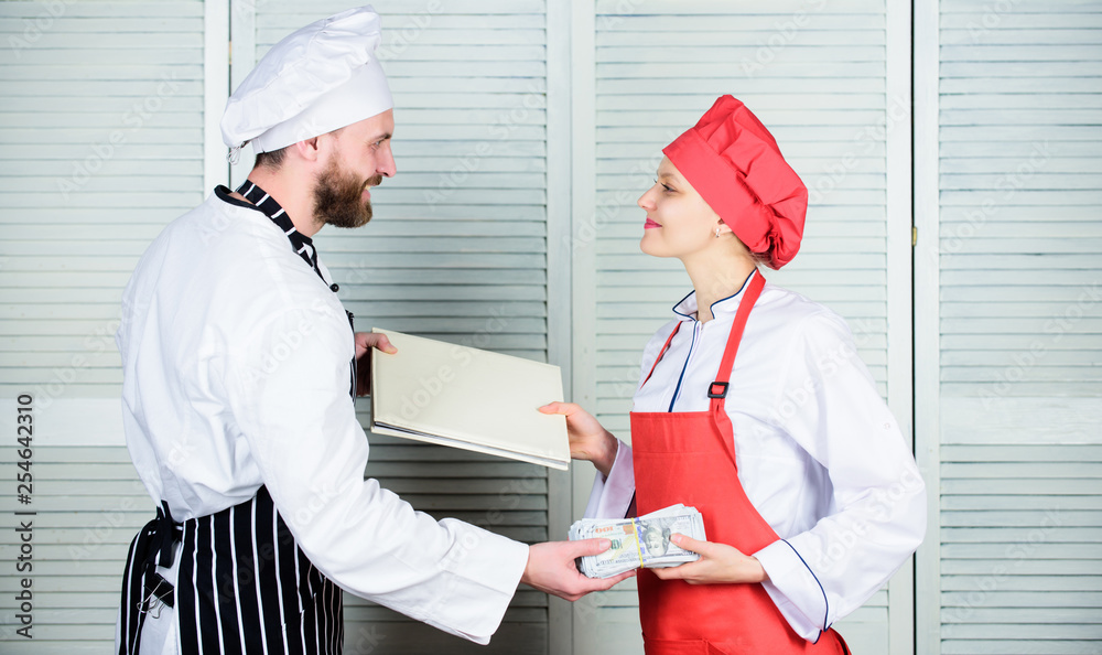 Cash in hand. Master cook and helper holding account book and cash money.  Cook helper giving cooking worksheet to chef. Female bookkeeper with  account report paying money. Restaurant balance book Stock Photo
