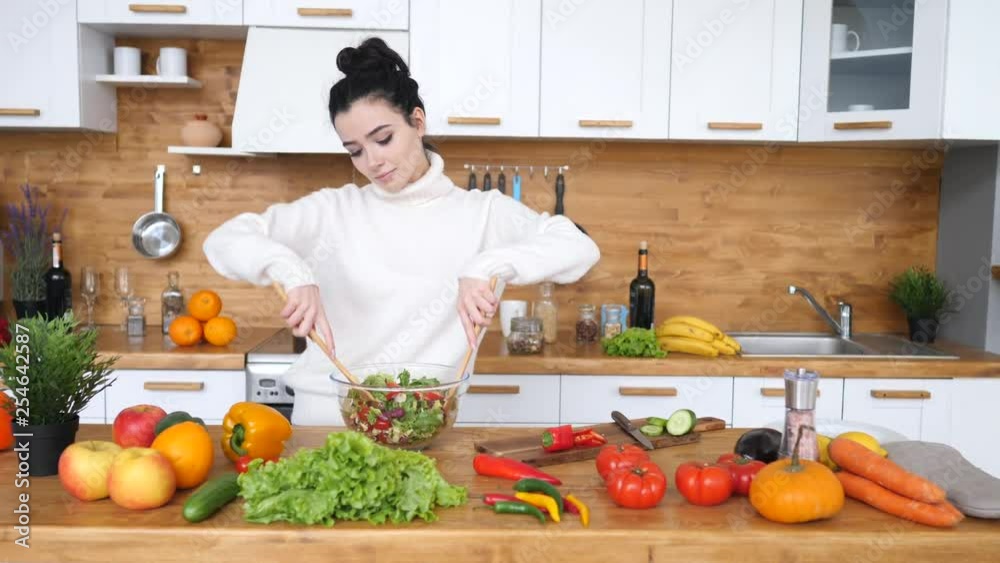 Young Woman Cooking Healthy Salad For Dinner On Her Kitchen. Young Woman Cooking Healthy Salad For Dinner On Her Kitchen.