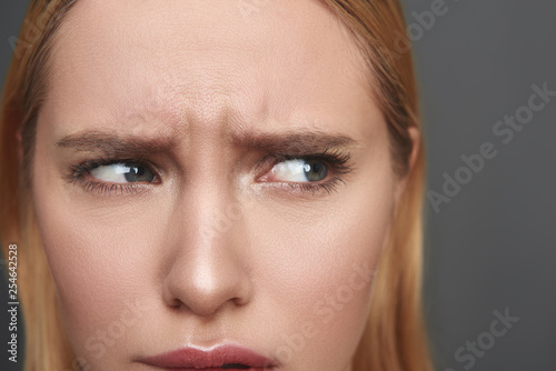 Close up of woman frowning and looking to the left